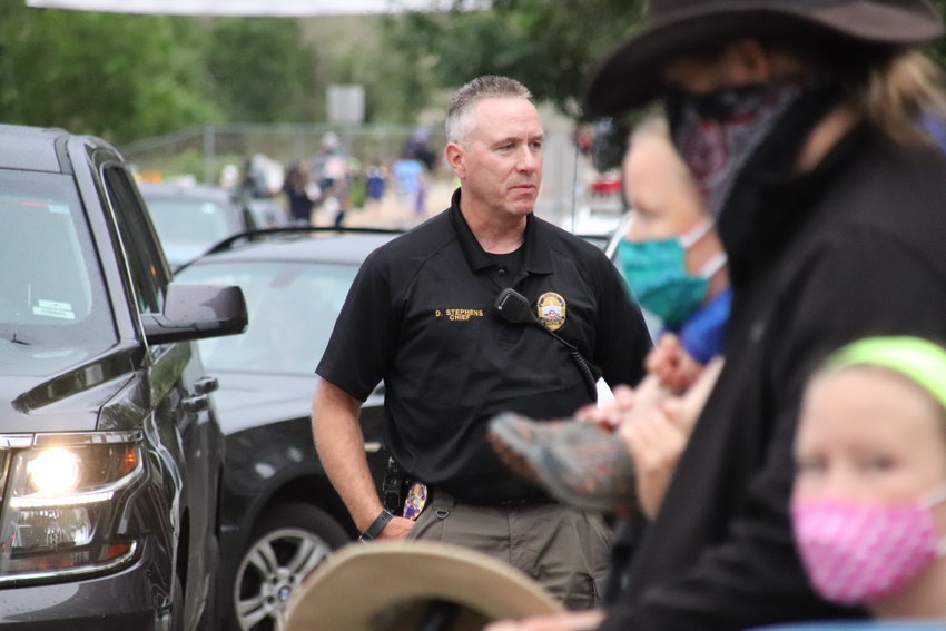Littleton Police Chief Doug Stephens watches people walk past as part of the Black Lives Matter Solidarity Walk in Littleton on June 18.